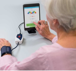 Older woman measuring blood pressure with tablet
